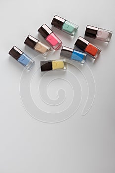 Collection of colored bottles of nail polish and gel. Layout for design.