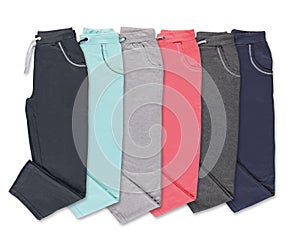 Collection of colored trousers on a white background.