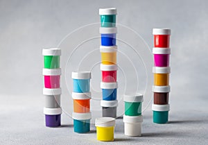 Collection of colorful cans of paint, on gray background