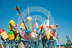 Collection of colorful fishing or lobster trap buoys and markers at wharf in Provincetown, Massachusetts, USA