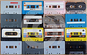 Collection of colorful old audio cassette tape on wooden background