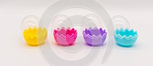 A collection of colorful plastic Easter eggs on white