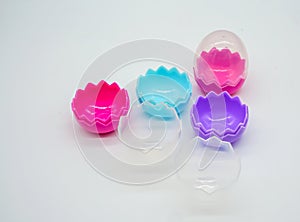 A collection of colorful plastic Easter eggs on white