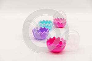 A collection of colorful plastic Easter eggs on white