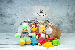 Collection of colorful toys on gray concrete background. Kids toys