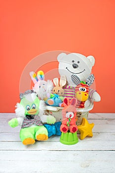 Collection of colorful toys on an orange background. Kids toys