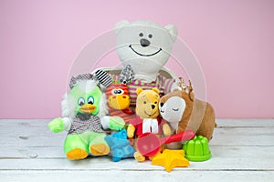 Collection of colorful toys on a pink background. Kids toys