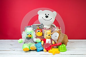 Collection of colorful toys on a red background. Kids toys