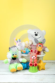 Collection of colorful toys on a yellow background. Kids toys