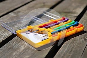 Collection of coloured screwdrivers on a wooden bench