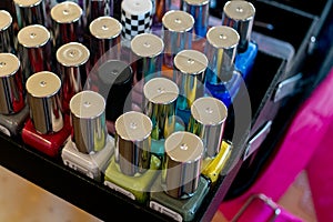 Collection of colourful nail polish bottles in black makeup box