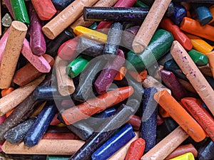 A collection of colourful used wax crayons