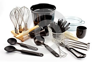 a collection of cooking utensils, including pots and pans, whisks and spoons, arranged on a white background