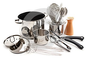 a collection of cooking utensils, including pots and pans, whisks and spoons, arranged on a white background