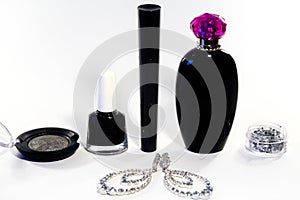 Collection cosmetics. Fashion set make-up accessories, nail polish, eyeshadows, mascara, perfume and brilliants earrings