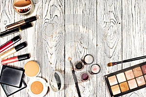 Collection of cosmetics for make-up artist. Powder, pigments, glitter, brushes and eyeliner. studio photo on a wooden background w