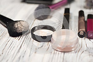 Collection of cosmetics for make-up artist. Powder, pigments, glitter, brushes and eyeliner. studio photo on a wooden background w