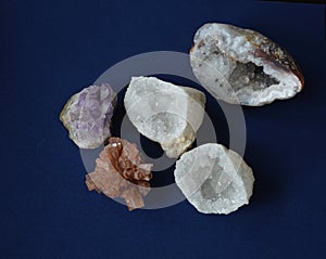 A Collection of Mineral Crystal Stones, various colours and textures, on Blue