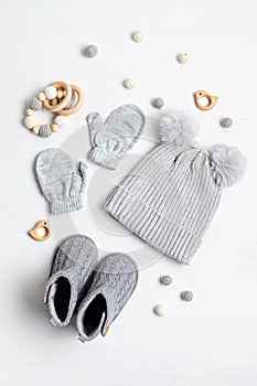 Collection of cute organic baby clothes and booties. Warm hat, mittens and boots