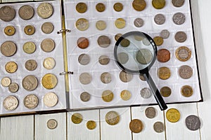 Collection of different coins in a numismatic album