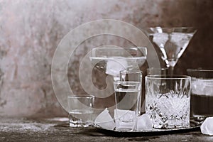 Collection of different glasses filled with cold water with ice