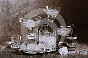 Collection of different glasses filled with cold water with ice