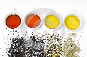 Collection of different teas in cups with tea leaves on a white background