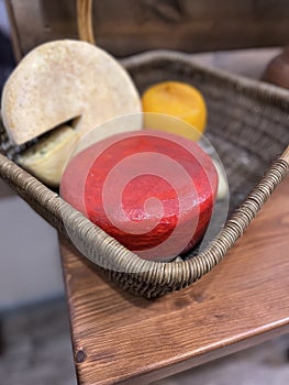 A collection of different types of cheese in a basket