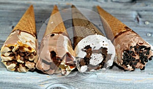 Collection of different types of Ice cream cones of cocoa chocolate and vanilla with topping of chocolate chips pieces in crispy