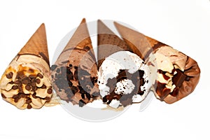 Collection of different types of Ice cream cones of cocoa chocolate and vanilla with topping of chocolate chips pieces in crispy