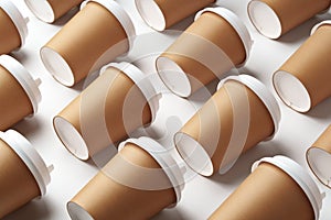 A collection of disposable paper cups arranged in a repeating pattern on a light background