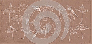 Collection of doodle vintage umbrellas on brown parcel paper background. Vector sketch illustration.