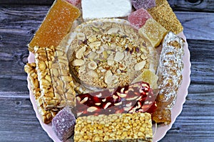 collection of Eastern candy chickpeas, peanuts, sesame, creamy taffy, sugar jelly, nuts, pistachios, hazelnuts disc as a