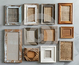 A collection of empty picture frames with varying textures and materials is carefully arranged in an overhead flat lay