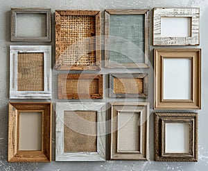 A collection of empty picture frames with varying textures and materials is carefully arranged in an overhead flat lay