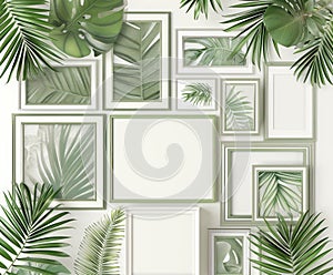 A collection of empty white picture frames of various sizes arranged haphazardly on a bed of lush tropical leaves.