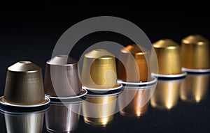 Espresso coffee pods isolated on black background, Closeup view with details, banner