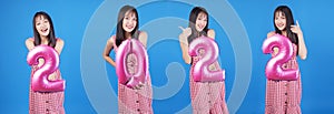 Collection festive happy new year concept.Excited cheerful young woman holding pink helium balloon number 2022 in own hands for