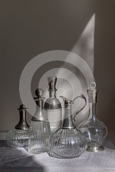 A collection of five clear glass decanters