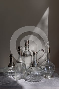 A collection of five clear glass decanters photo