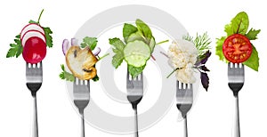 Collection of forks with herbs and vegetables isolated on white