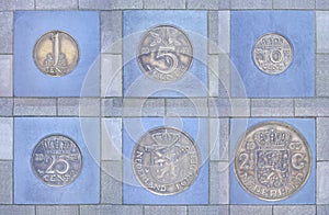 Collection of former Dutch coins in pavement