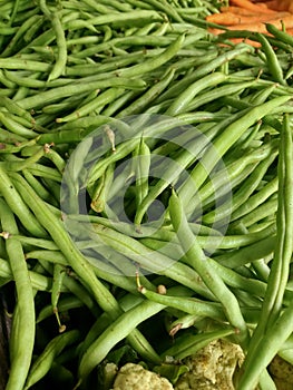 Collection of fresh green string beans in the market