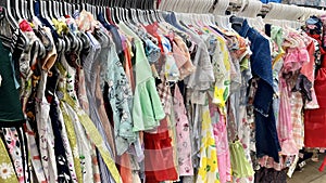 Dresses are properly arranged in the cloth shop photo