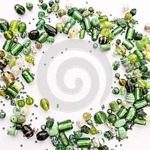 Collection of green glass beads shaped into off center garland