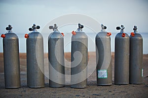 Collection of grey scuba diving air oxygen tanks.