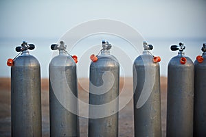 Collection of grey scuba diving air oxygen tanks.