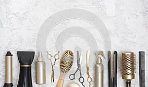 Collection of hairdresser tools on marble background with copy space