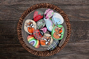 Collection of Hand Painted Colorful Cartoon Rocks in w Wicker Ba