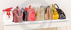 Collection of handbags standing in a row